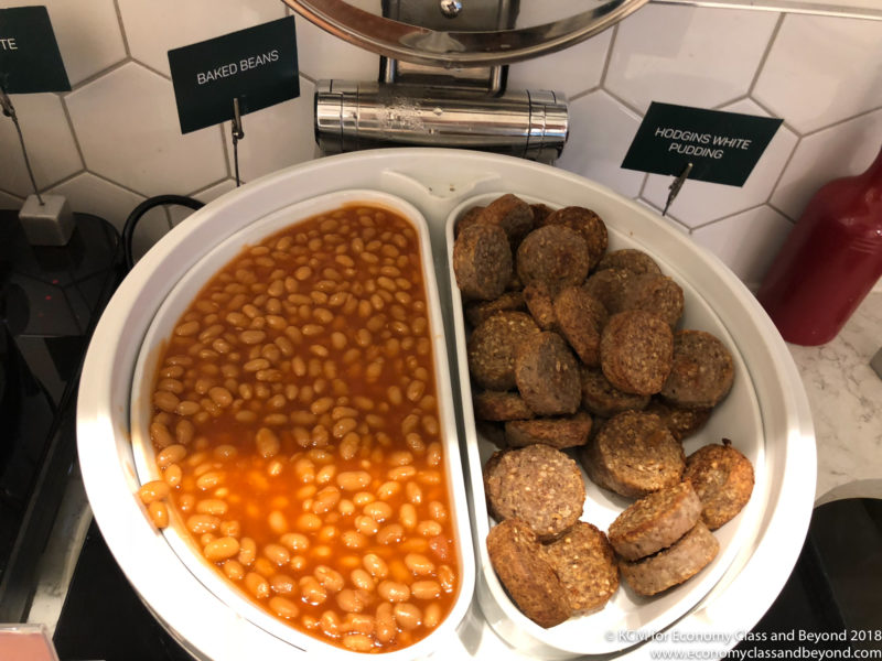 a plate of baked beans and meatballs