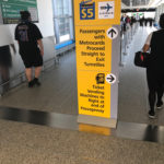 a yellow sign in a airport