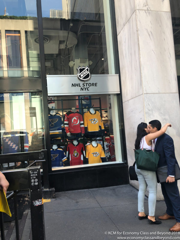 a man and woman kissing in front of a store