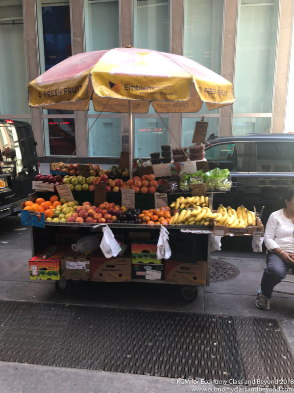 a fruit stand with umbrella