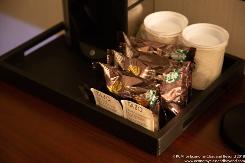 a tray of coffee packets and cups