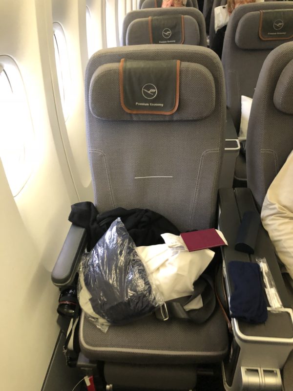 a seat with a bag and a camera on it