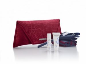 a red clutch bag with a red bag and a toothbrush