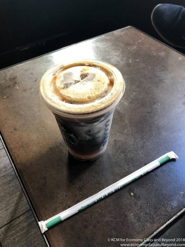 a plastic cup with a lid and a straw on a table