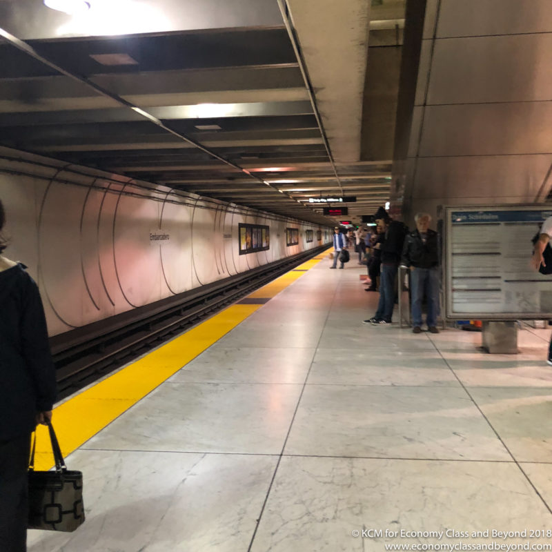 people standing in a subway station