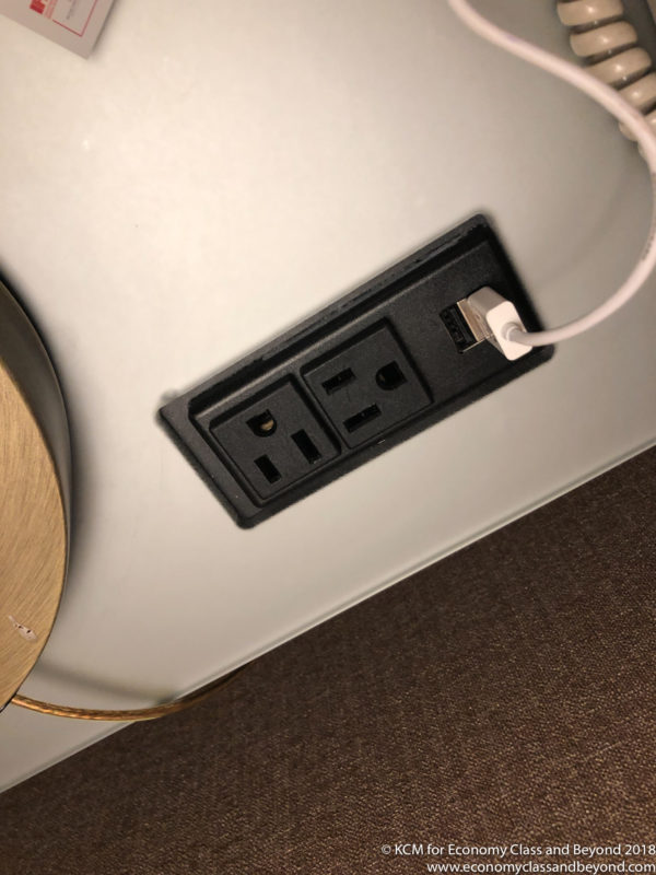a black outlet with a white cord plugged into it
