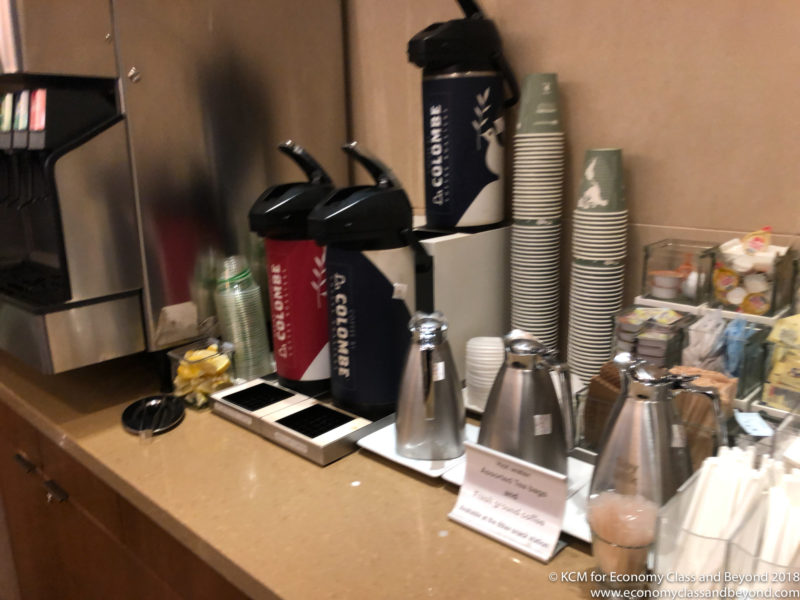 a coffee maker and cups on a counter