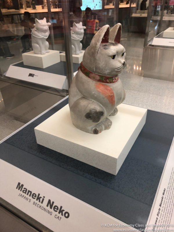 a statue of a cat on a display case