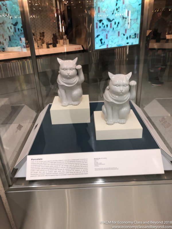 a couple of white cats on a display
