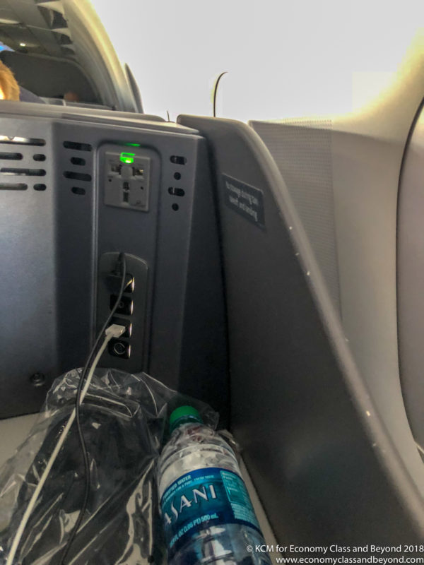 a bottle and a plastic bag next to a power outlet