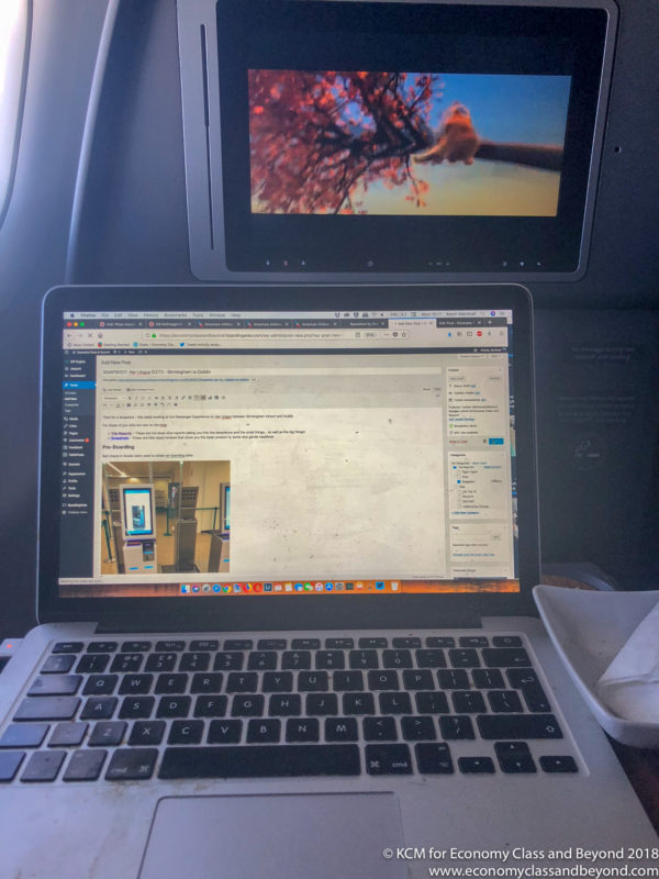 a laptop and tablet on a plane
