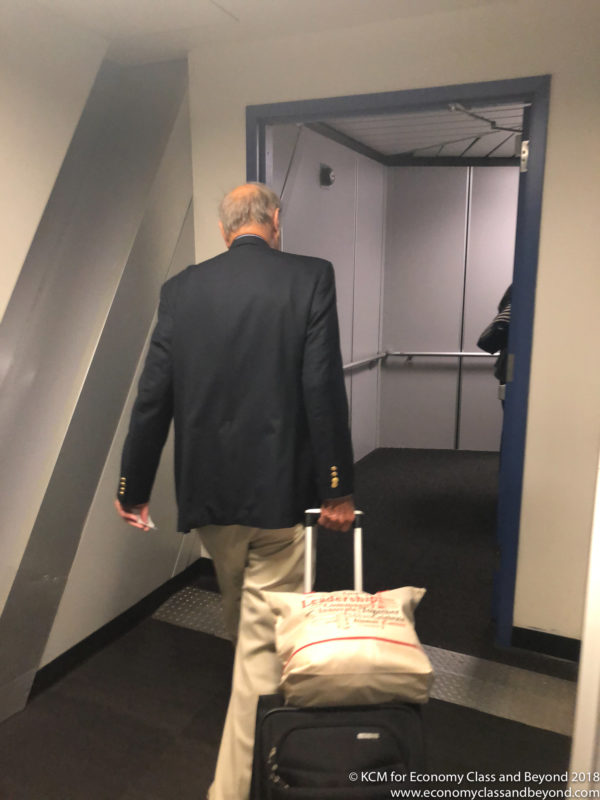 a man in a suit walking with a bag
