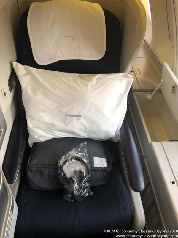 a seat with a pillow and headphones on it