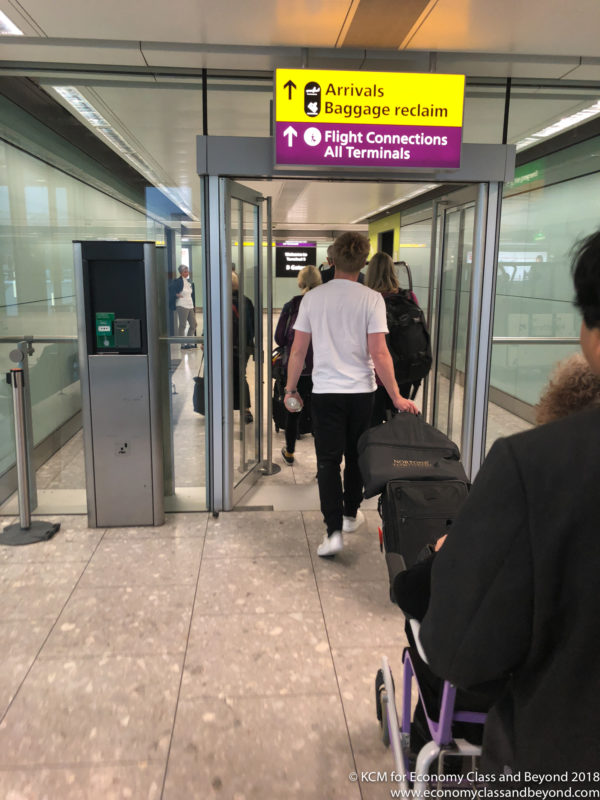 a group of people walking through an airport