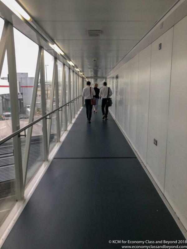 a group of people walking down a hallway