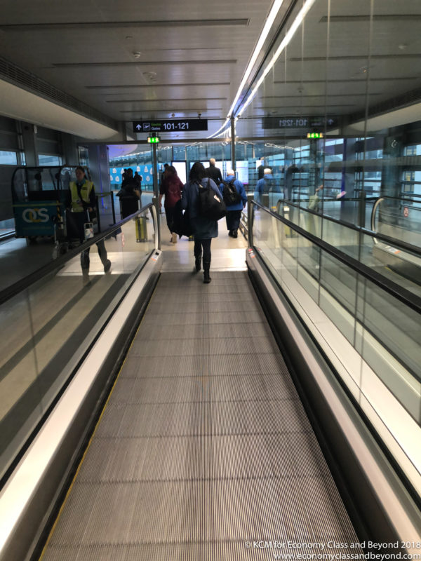 people walking on an escalator
