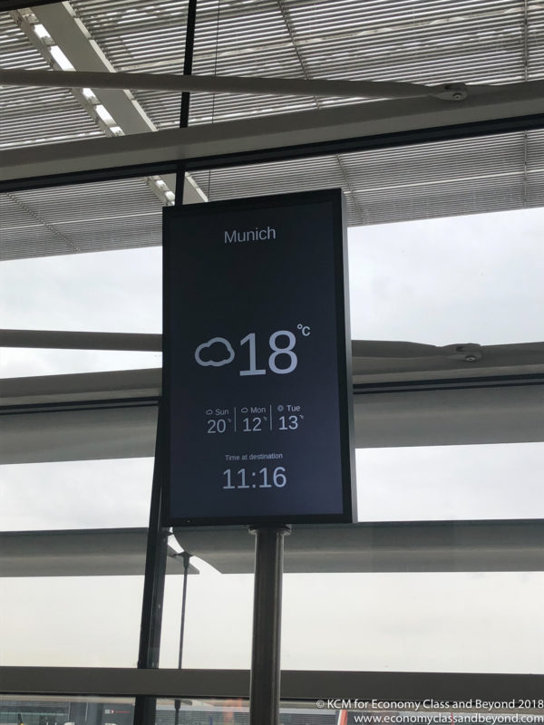 a sign with a weather and time