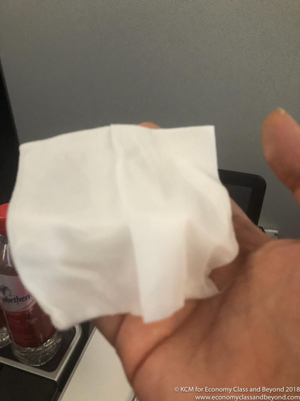 a hand holding a tissue