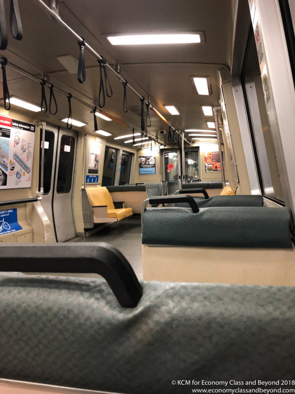 inside a train with seats and a seat belt