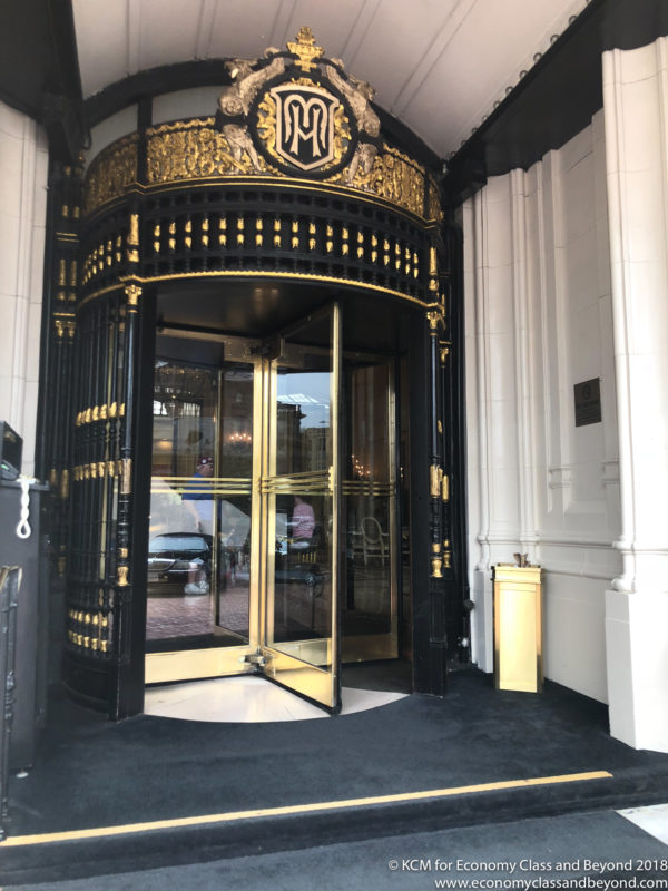 a black and gold entrance with glass doors