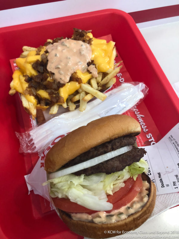 a burger and fries on a red tray