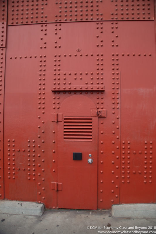 a red metal door with holes