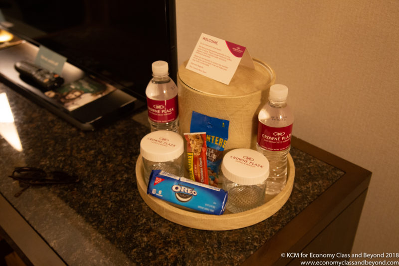 a hotel room service tray with food and drinks