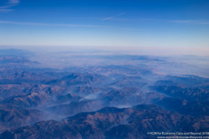 a aerial view of mountains and blue sky