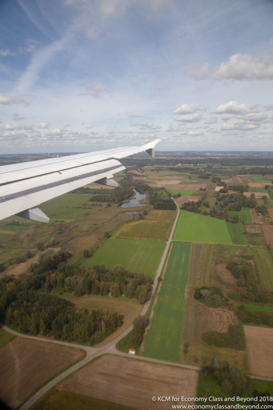 an airplane wing over a landscape
