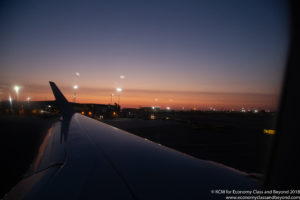 an airplane wing at dusk