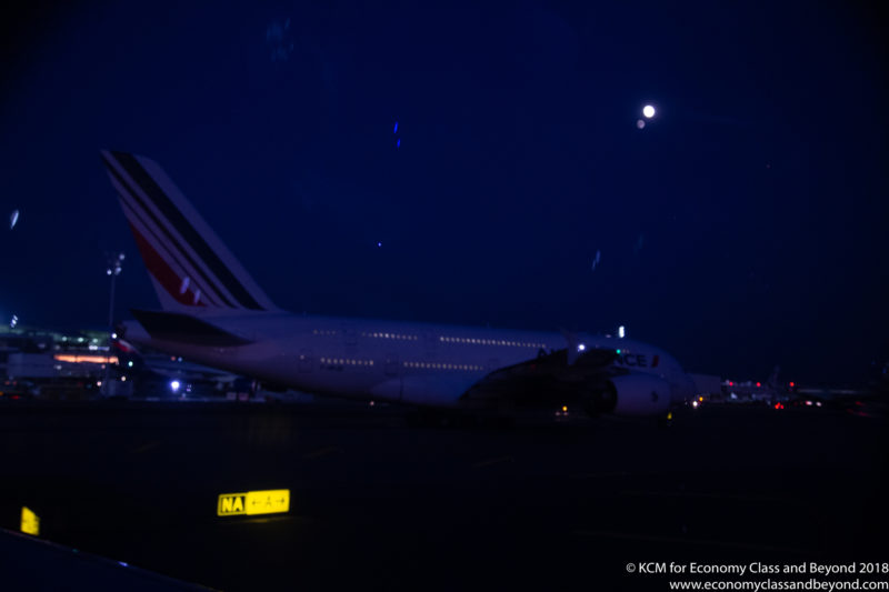 a plane at night with the moon in the background
