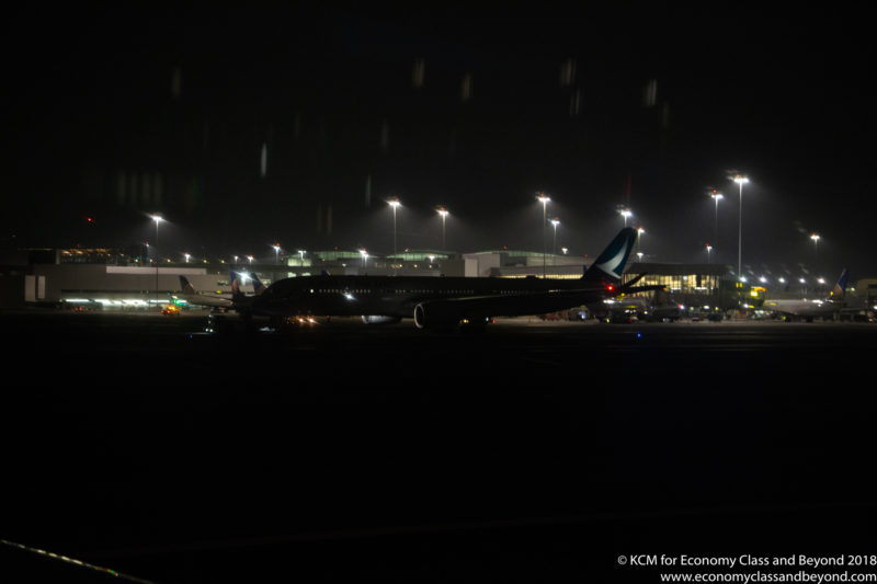 an airplane at night with lights in the background