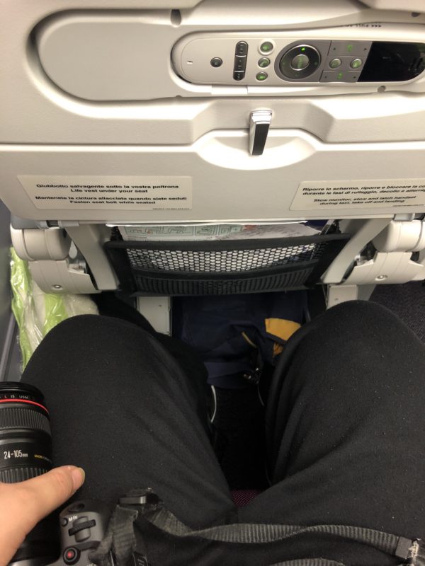 a person's legs in an airplane