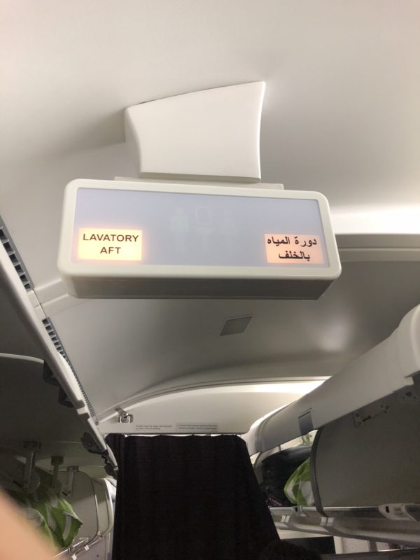 an airplane seat with a sign