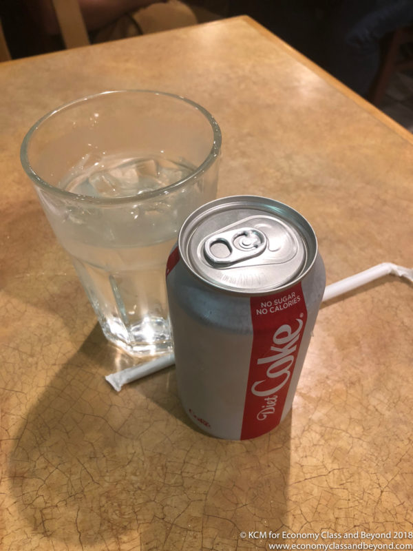 a soda can and a glass of water
