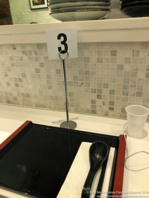 a spoon and a tray with a number on it