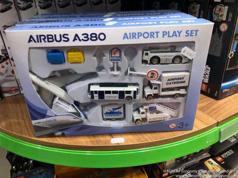 a toy airplane and bus in a box