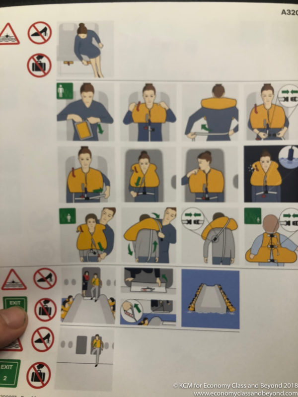a hand holding a poster with instructions on how to tie a safety belt