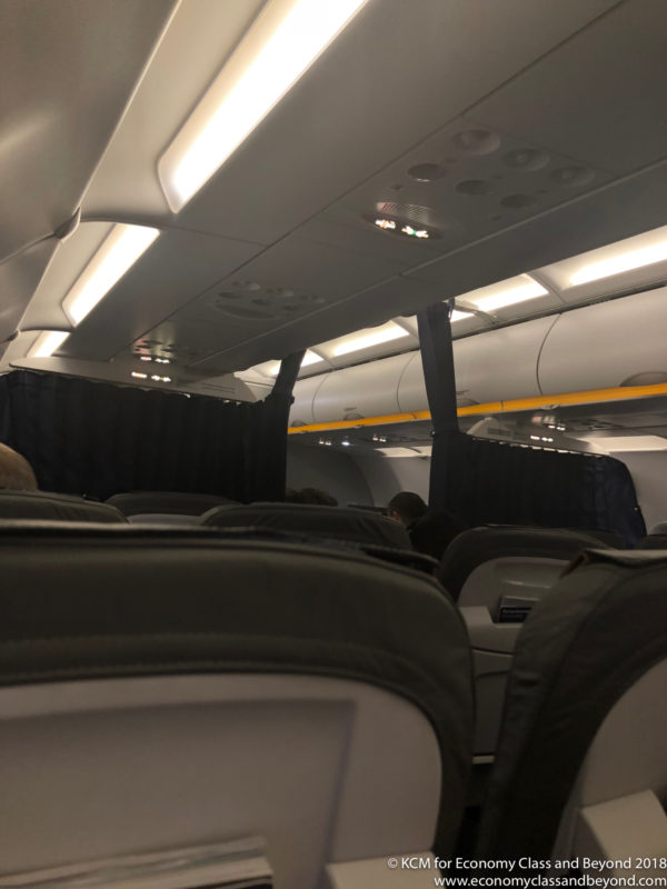 a plane with black seats and a yellow pole