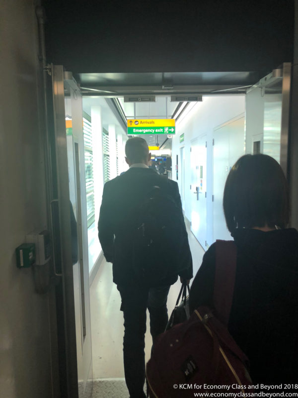 a man and woman walking in a hallway