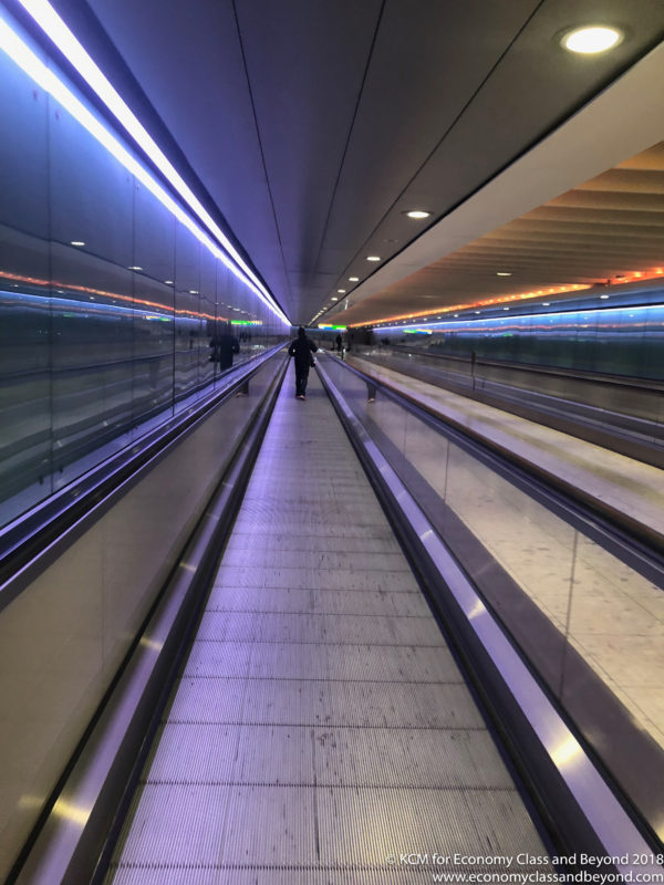 a person walking on an escalator