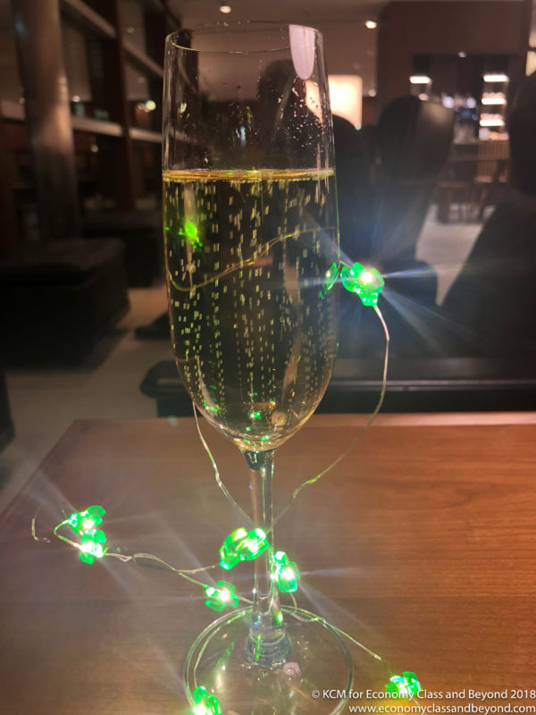 a glass of champagne with lights on it