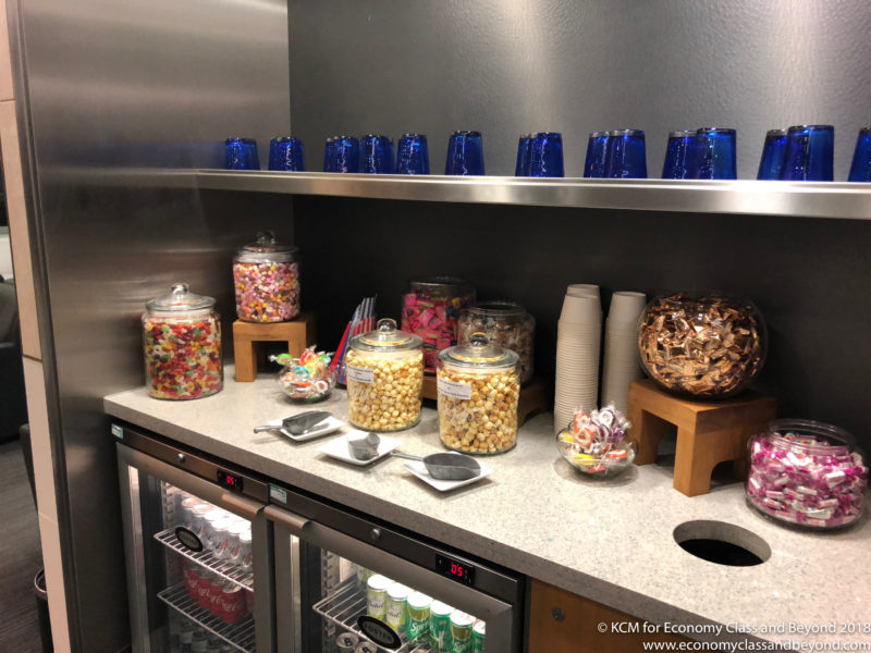 a counter with a variety of candy and drinks