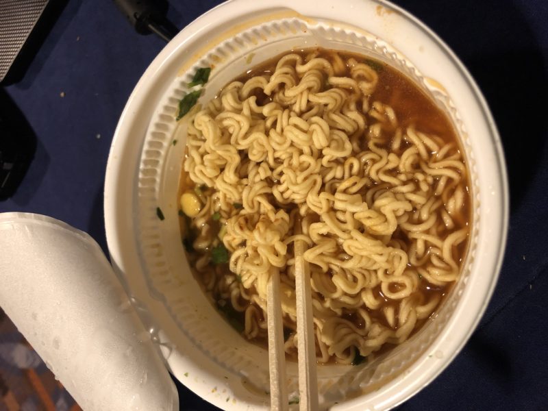 a bowl of instant noodles with chopsticks