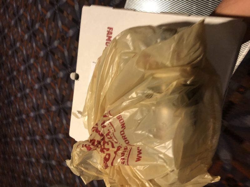 a plastic bag on a pizza box