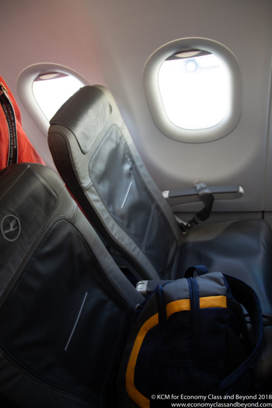 a seat in an airplane with a backpack