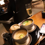 a plate of soup and a glass of champagne on a table