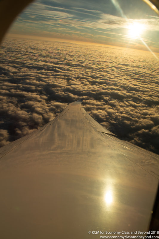 the wing of an airplane above the clouds