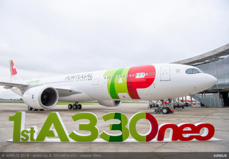 a large white airplane with red and green text