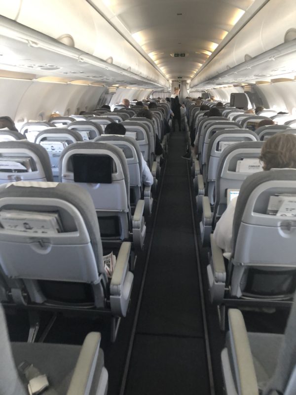 an airplane with people sitting in the seats